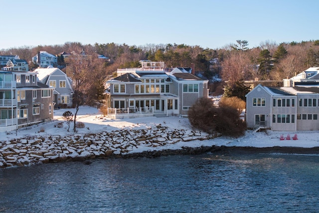 rear view of property featuring a water view