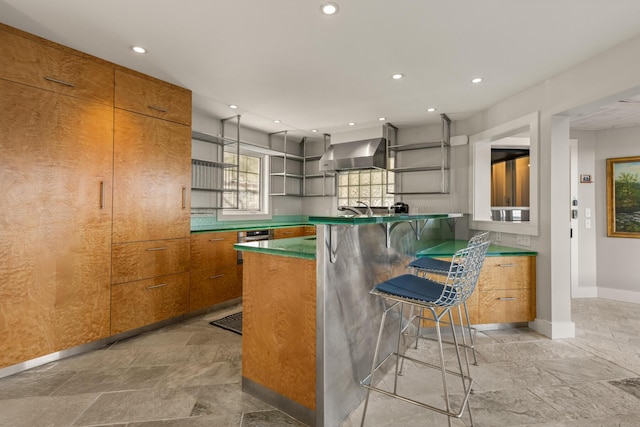 bar featuring sink, wall oven, and wall chimney range hood