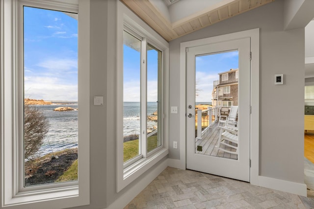 doorway featuring a water view, plenty of natural light, and lofted ceiling