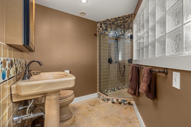 bathroom with sink, toilet, and walk in shower