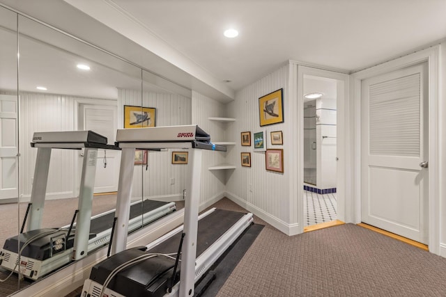 workout room featuring carpet and crown molding