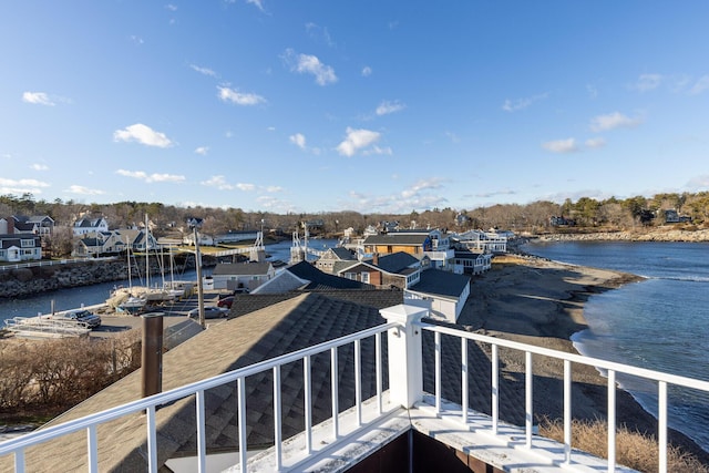 view of dock with a balcony and a water view