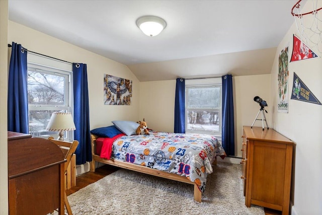 bedroom with dark wood-type flooring and lofted ceiling