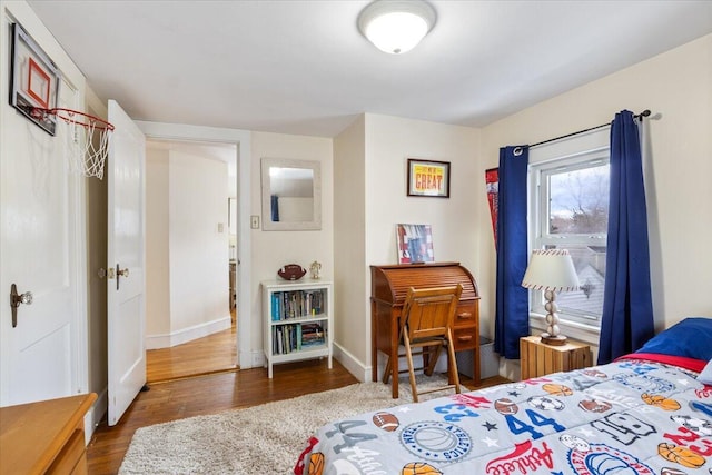 bedroom with dark hardwood / wood-style floors