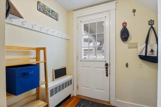 doorway featuring hardwood / wood-style floors and radiator heating unit