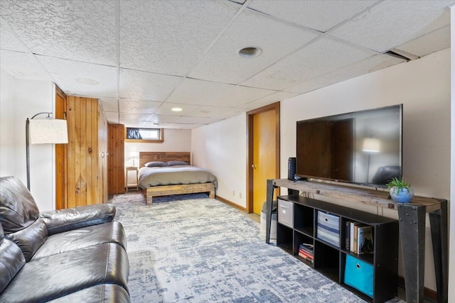 carpeted bedroom featuring a paneled ceiling