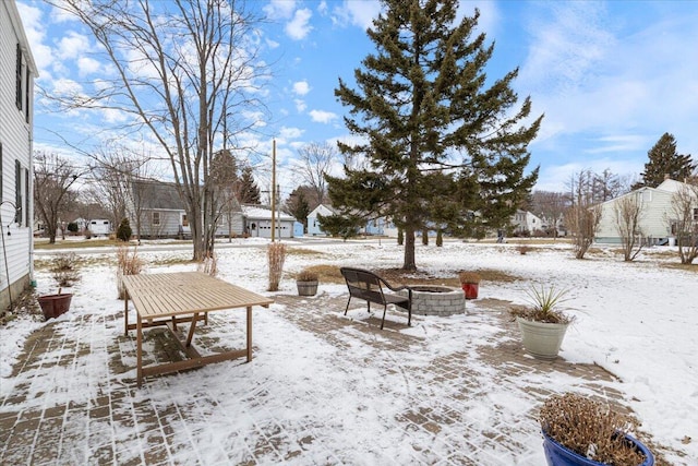 snowy yard with an outdoor fire pit