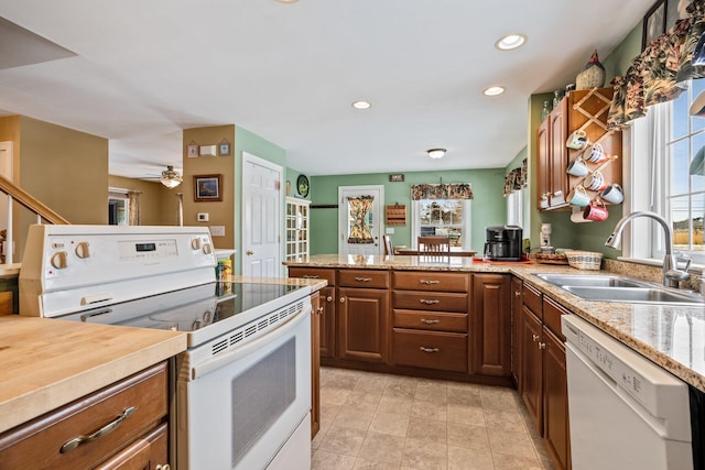 10 Seaside Ave, Saco, ME 04072 - kitchen featuring white appliances, a sink, a peninsula, recessed lighting, and brown cabinets
