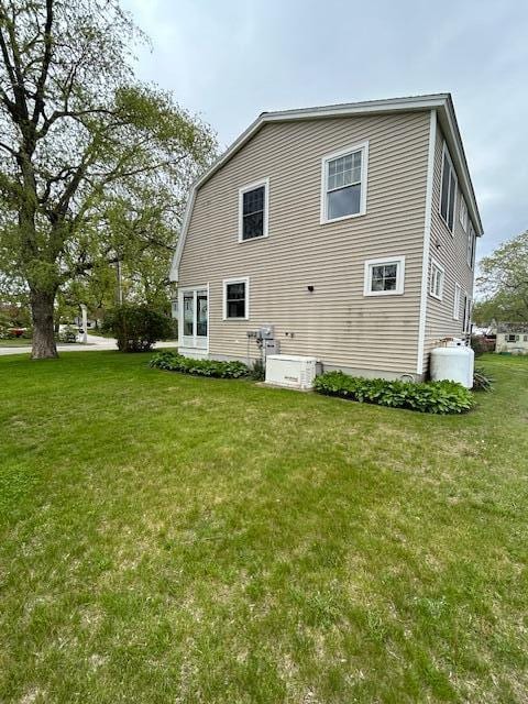 10 Seaside Ave, Saco, ME 04072 - rear view of house featuring a lawn