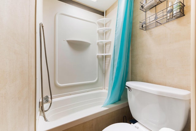 bathroom with shower / bathtub combination with curtain and toilet