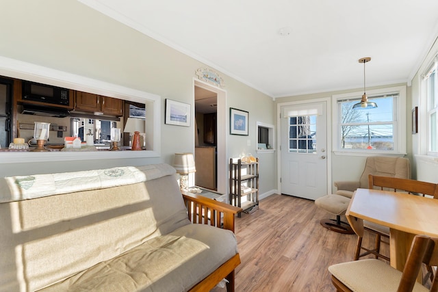sitting room with light hardwood / wood-style flooring and ornamental molding
