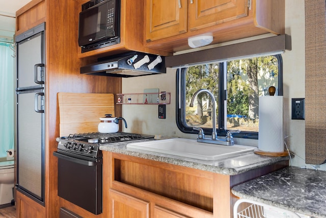 kitchen featuring extractor fan, sink, and black appliances