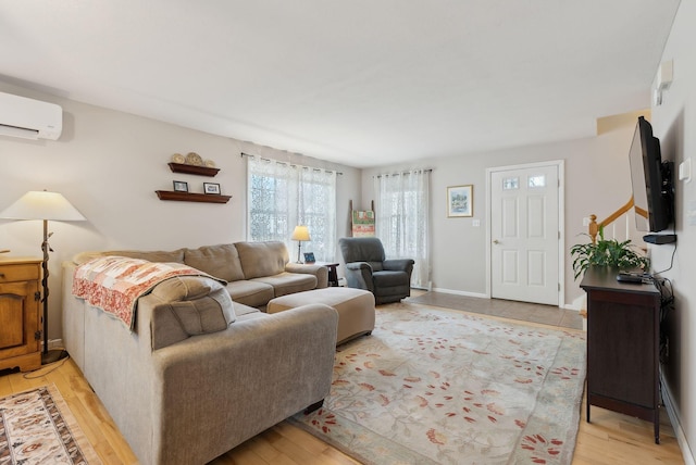 living room featuring light wood-type flooring and a wall mounted AC