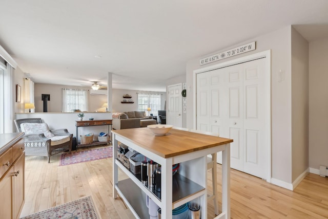 dining area featuring ceiling fan and light wood-type flooring