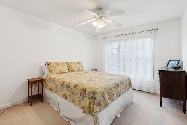 bedroom with light carpet and ceiling fan