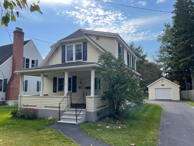 view of front of home with an outbuilding, a garage, and a front yard