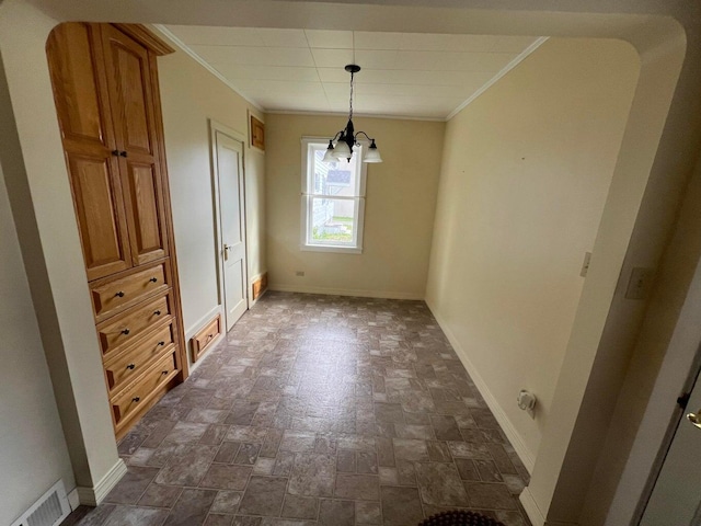 unfurnished dining area with an inviting chandelier and crown molding