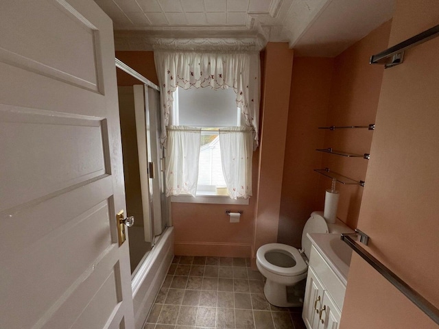 full bathroom with vanity, bath / shower combo with glass door, and toilet