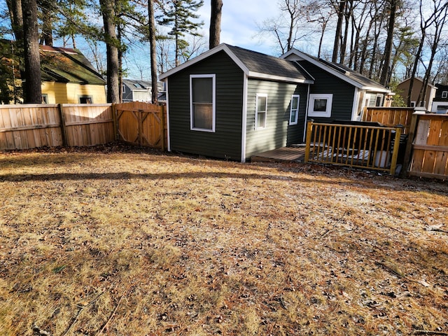 rear view of property featuring a deck