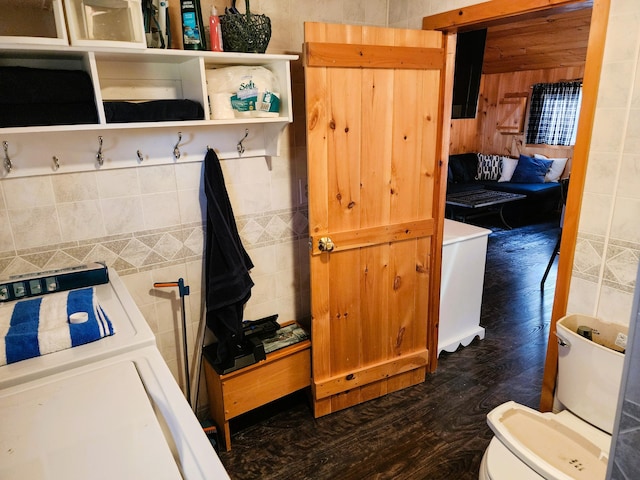 bathroom featuring hardwood / wood-style floors, toilet, and washer / clothes dryer