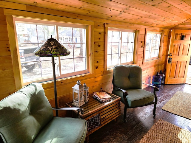 living area with wooden ceiling, dark wood-type flooring, wooden walls, and vaulted ceiling