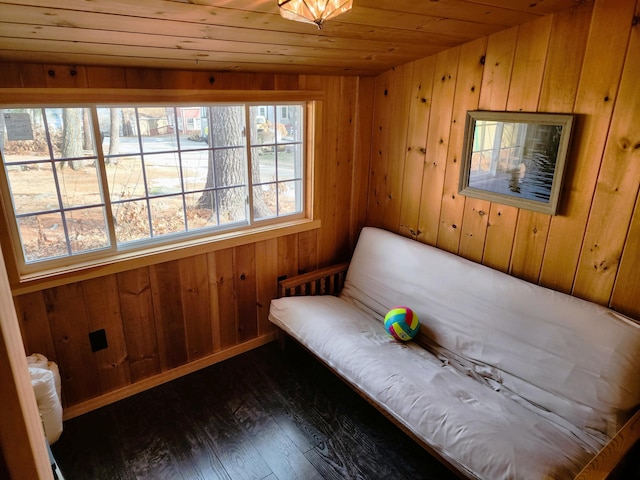 living area with dark hardwood / wood-style floors, wooden walls, and wood ceiling