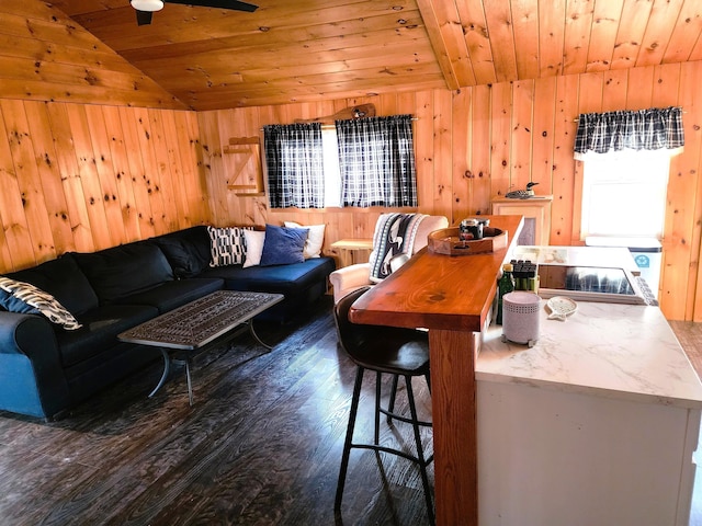 living room with dark hardwood / wood-style floors, wood ceiling, wooden walls, and vaulted ceiling