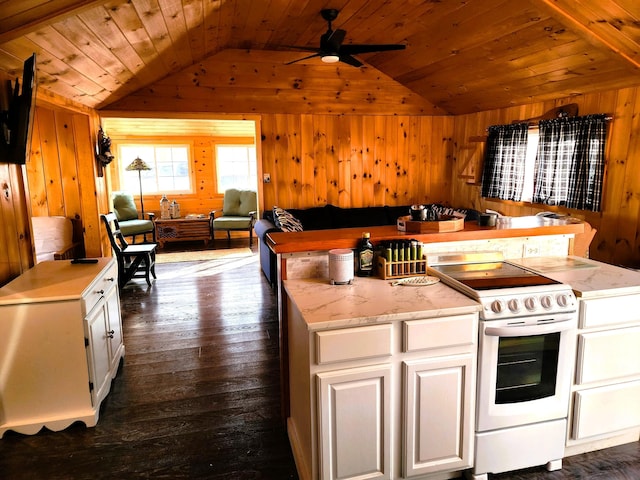 kitchen with white range with electric stovetop, wood walls, white cabinets, and vaulted ceiling