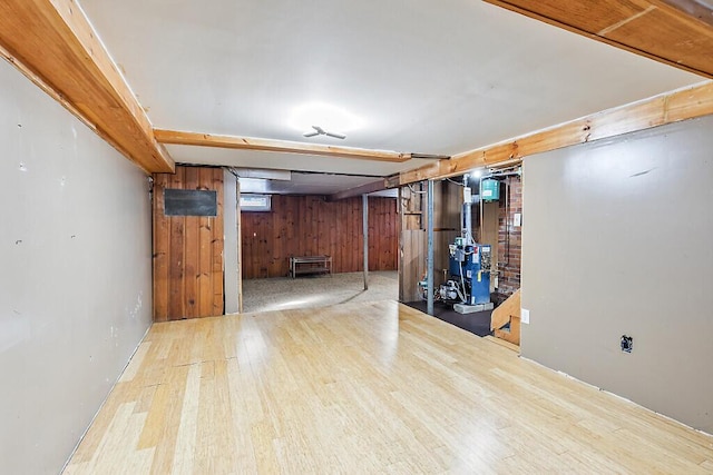 basement featuring hardwood / wood-style floors and wooden walls