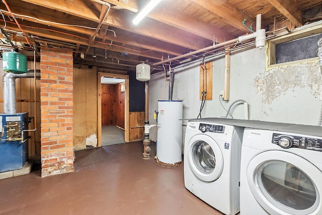 washroom featuring electric water heater and separate washer and dryer