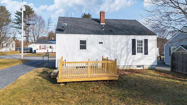 back of house featuring a yard and a wooden deck