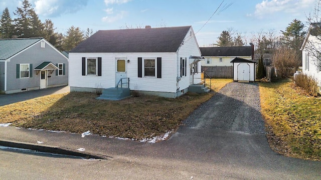 bungalow featuring a storage unit