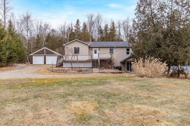 view of front facade with a garage, a deck, a front lawn, and an outdoor structure