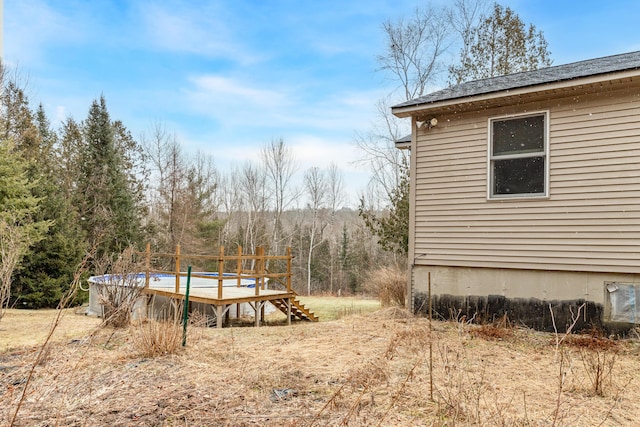 view of yard with a swimming pool side deck