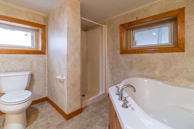 bathroom featuring toilet and separate shower and tub