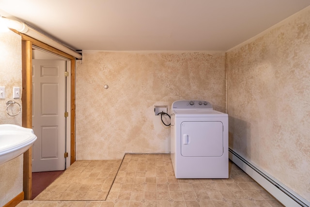 washroom with baseboard heating and washer / clothes dryer