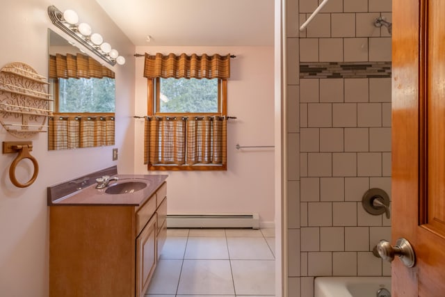 bathroom featuring baseboard heating, tile patterned floors, vanity, and tiled shower / bath combo