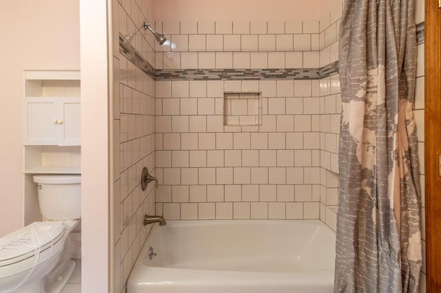 bathroom with toilet and shower / bath combo with shower curtain