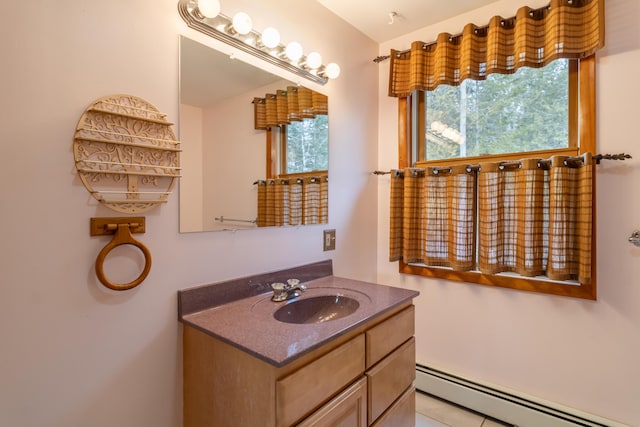 bathroom featuring a baseboard heating unit and vanity