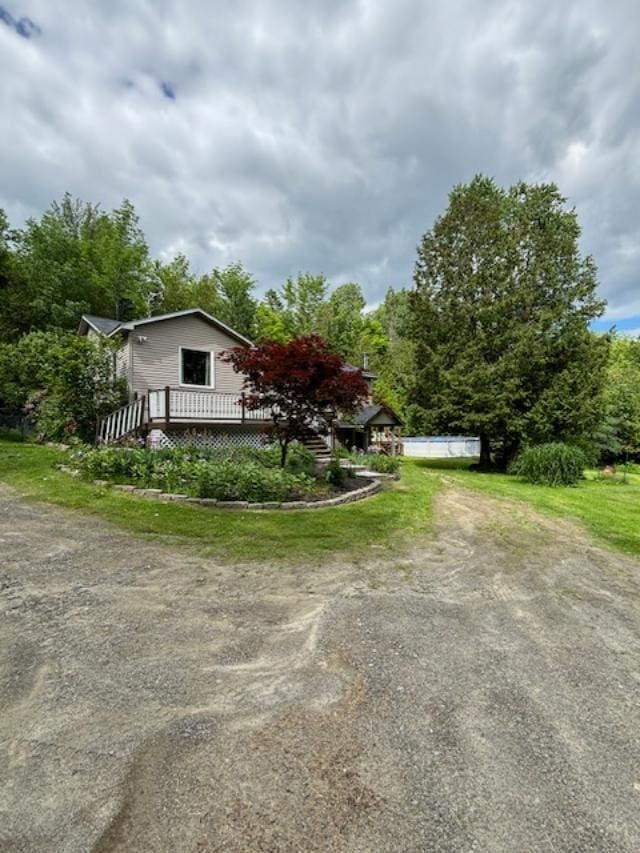 view of property exterior with a pool side deck