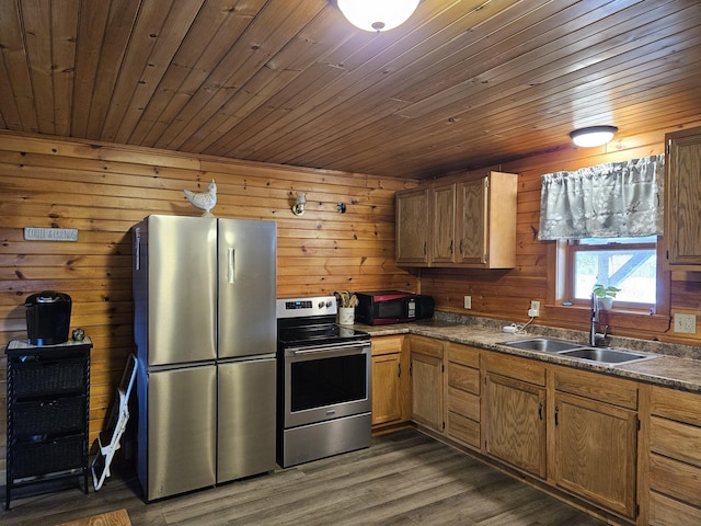 kitchen with wood walls, wood ceiling, sink, and appliances with stainless steel finishes