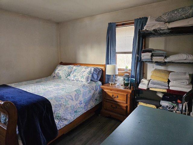 bedroom with dark wood-type flooring