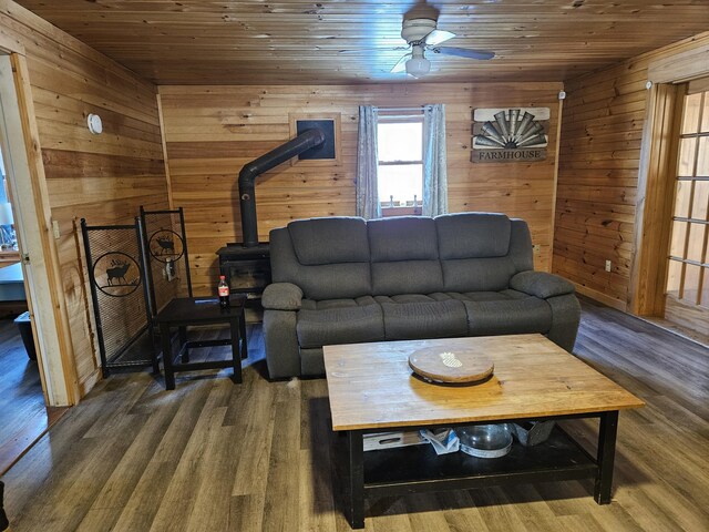 living room featuring wood walls, ceiling fan, wood ceiling, and dark hardwood / wood-style floors