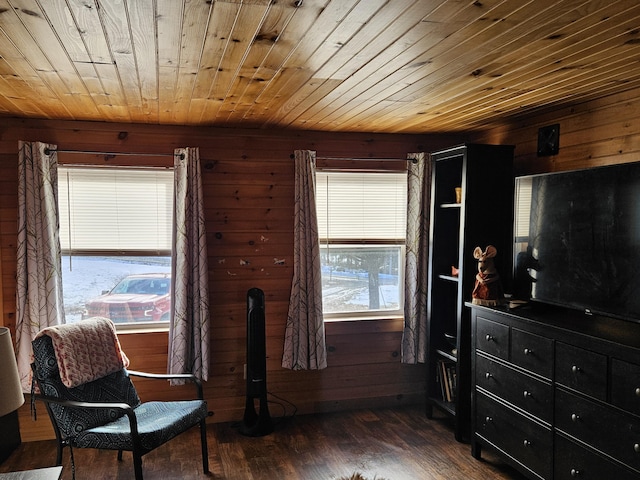 sitting room with dark hardwood / wood-style floors, wood walls, and wooden ceiling