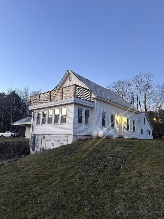 view of side of property with a lawn