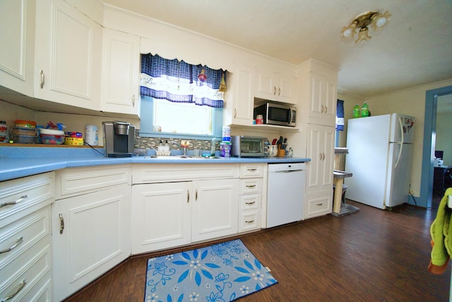 kitchen featuring sink, white cabinets, and white appliances