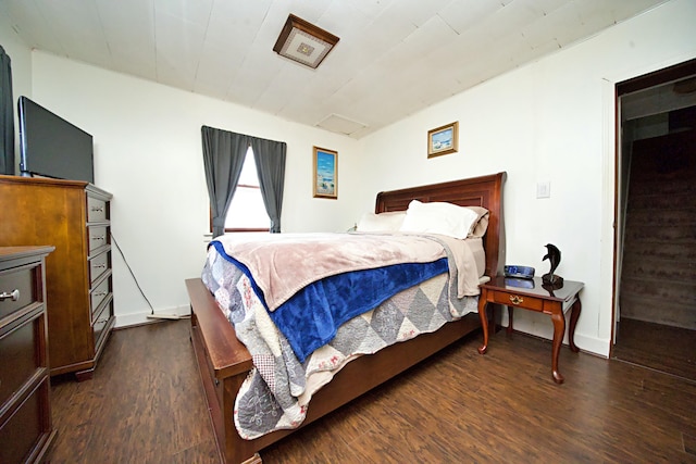 bedroom with dark hardwood / wood-style flooring