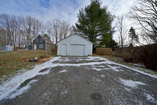 exterior space with a garage and an outdoor structure