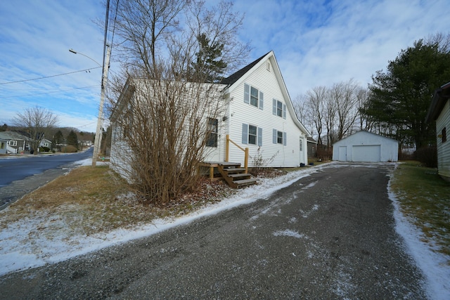 view of front of home featuring a garage and an outdoor structure