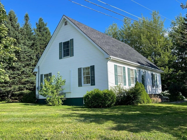 view of side of home with a yard